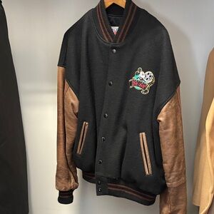 Black and Brown Leather-Sleeve Varsity Jacket with Embroidered Crest